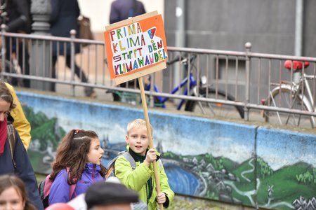 Auf dem Weg nach Paris zeigen Pilgerinnen und Pilger Solidarität mit den vom Klimawandel besonders betroffenen Menschen. Am 30. Oktober 2015 führt eine Etappe vom alten Bonner Rathaus am Rhein entlang zur UN. Bild: Kinder auf dem Weg zum UN-Klimasekr