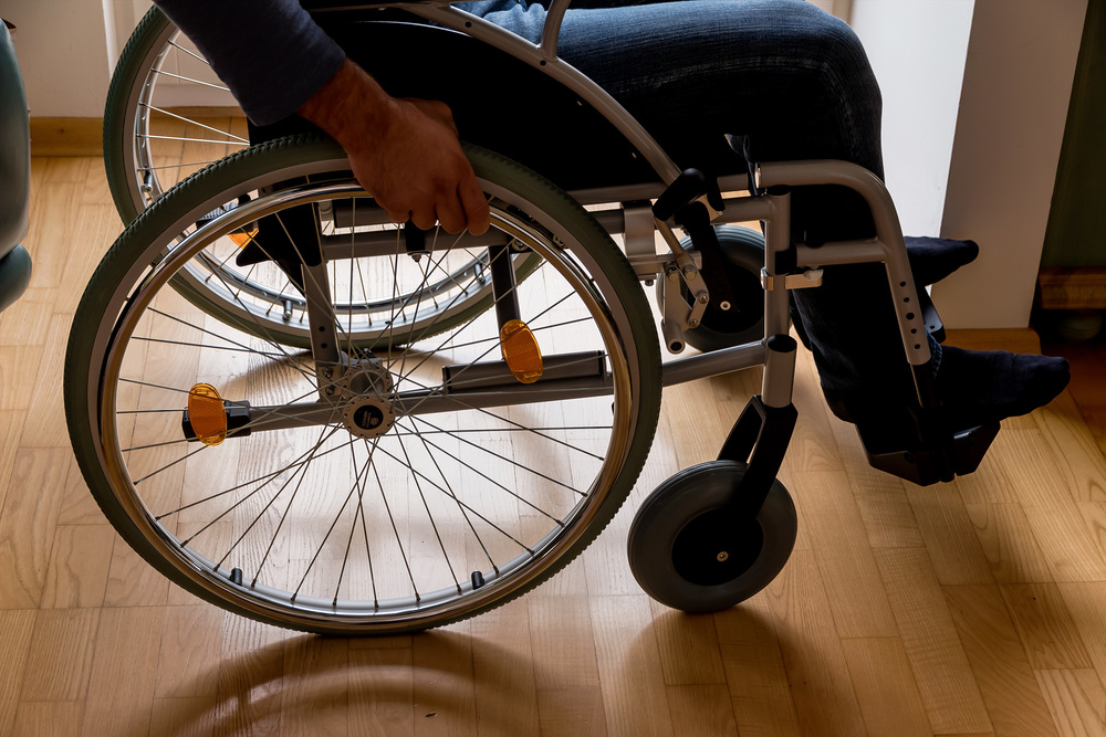 Ein Mann sitzt in einem Rollstuhl.