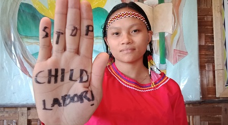 Aktivistin signalisiert 'Kinderarbeit stoppen'