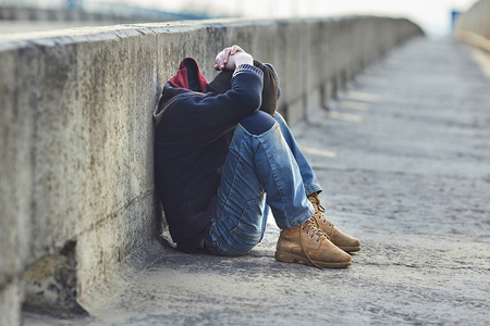 young homeless boy sleeping on the bridge, poverty, city, street