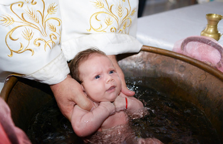 Newborn baby water baptism ritual / nickolae - Fotolia