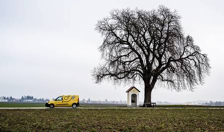 Alkoven, Österreich - 12/29, 2018: Zusteller der österreichischen Post liefert Pakete und Briefe aus.