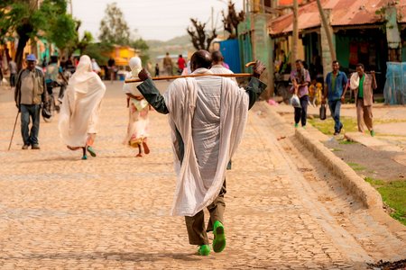 People on the streets of Aksum, Tigray.The current photo is taken from flickr.com: https://www.flickr.com/photos/rod_waddington/52221309484Link to the license (free with credit to the photographer): https://creativecommons.org/licenses/by-sa/2.0/