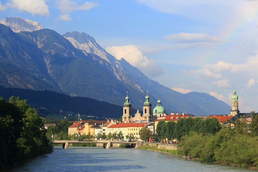 Inn-Bridge and Innsbruck skyline with a rainbow